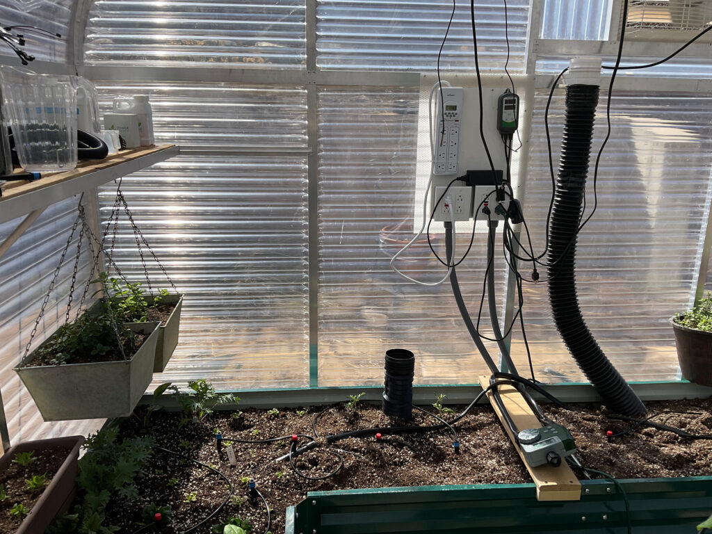 inside a sunlgo greenhouse with an infrared heater, greenhouse exhaust fan, climate controls, and gaht lite